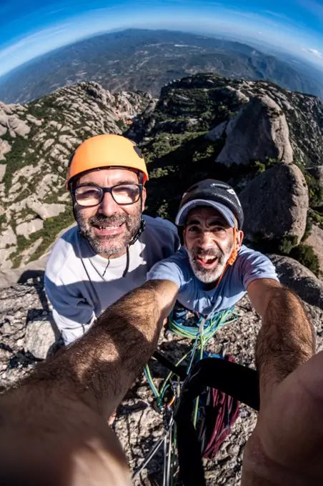 two  veteran climbers selfie at summit