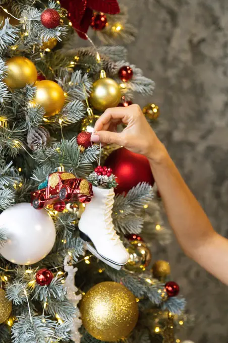 Christmas tree with Christmas gold and red toys, toy car and skate