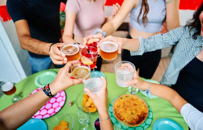 Aerial shot of unrecognizable Friends Toasting At Outdoor Party