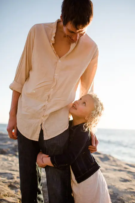 Daughter Grabbing Dad's Leg on Beach at Sunset in San Diego