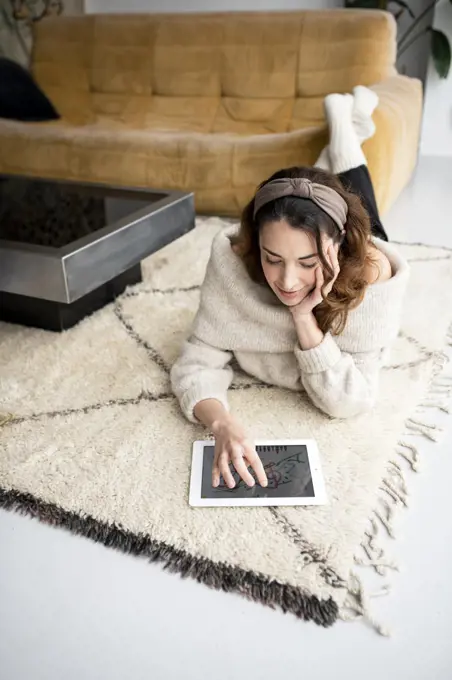 Young woman using digital tablet at home