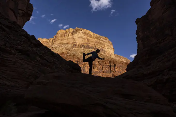 A woman doing a yoga pose in the Grand Canyon.