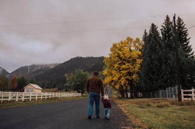 dad and daughter taking a walk outdoors in the autumn with mount