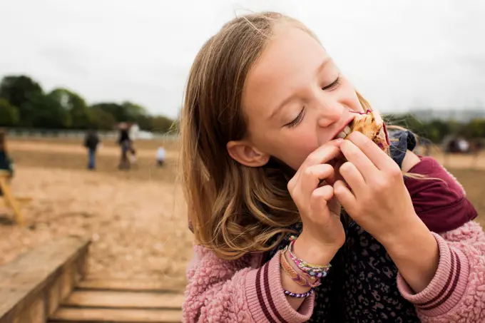 child enjoying street food whilst at a festival