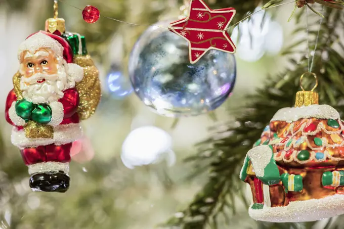 House and Santa Claus hanging on Christmas tree, Munich, Germany