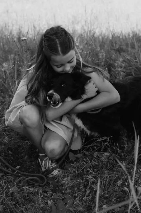 Happy girl hugging her dog outdoors. Lifestyles and pet care concept.