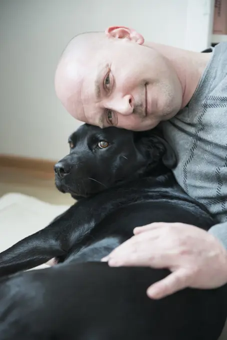 Portrait of man with his dog, smiling