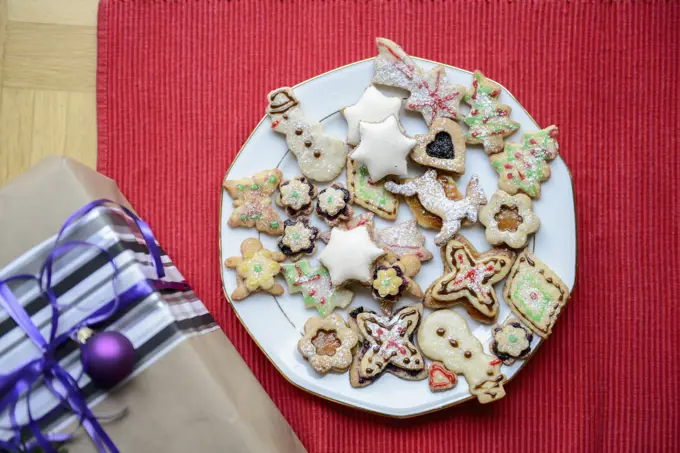 High angle view of gift box and gingerbread Christmas cookies in plate, Bavaria, Germany