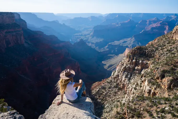 Woman Overlooking Hazy Grand Canyon in Arizona