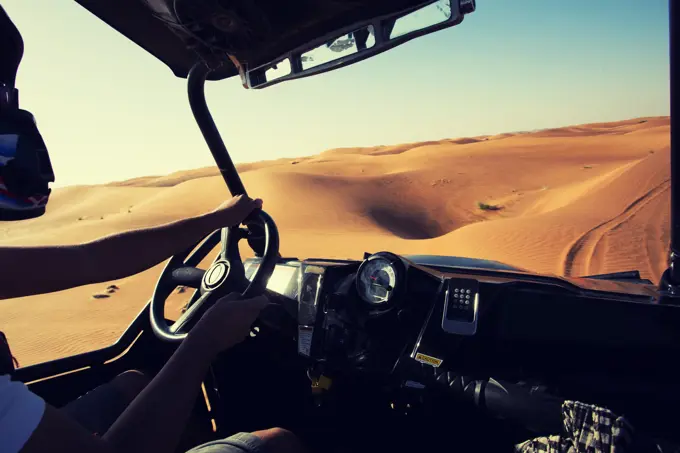 Driving quad bike, buggy at Dubai desert sand dunes