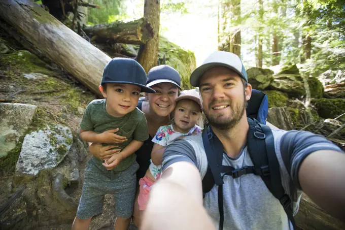 Family of four takes a selfie while hiking near Vancouver, Canada.