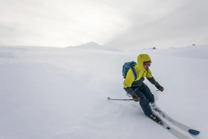 Skier enjoying fresh tracks on a remote mountain in Canada