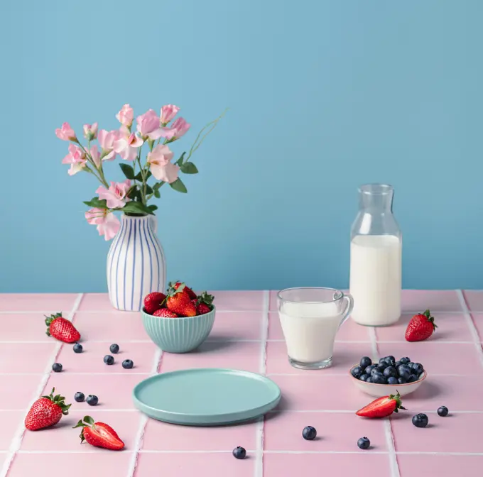 Healthy food. Table setting with berries strawberries glass of milk.