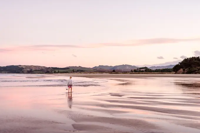 Young female on remote beach in New Zealand