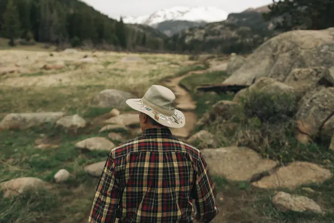 A retired man walks along a trail in Rocky Mountain National Park, CO.