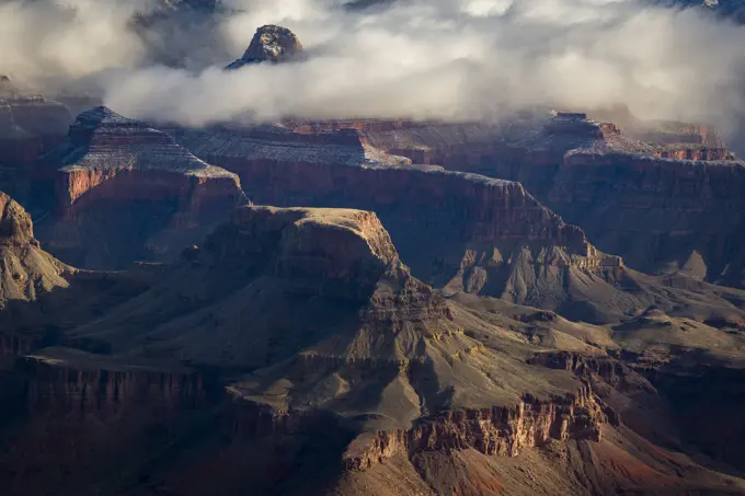 Rock formations shrouded in clouds at the Grand Canyon in winter