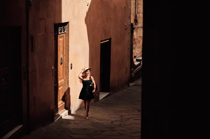 Female tourist walking on narrow street