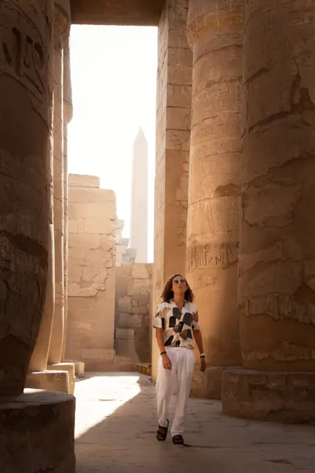 Man with sunglasses, walking around the Hypostyle hall, Karnak Temple