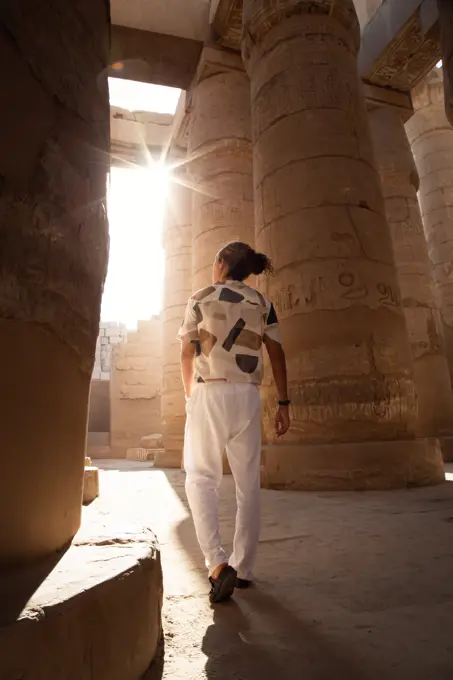 Man with hairbun, walking around the Hypostyle hall, Karnak Temple