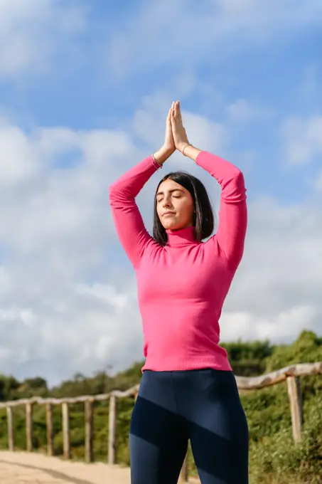 Young woman doing yoga in the park, healthy lifestyle