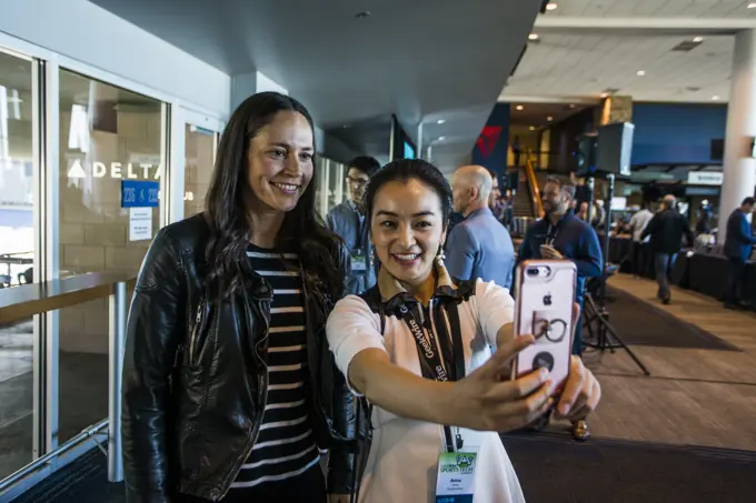 Fangirl taking selfie with female athlete, Seattle, Washington, USA