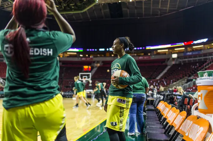 Female basketball players warming up before game, Seattle, Washington, USA