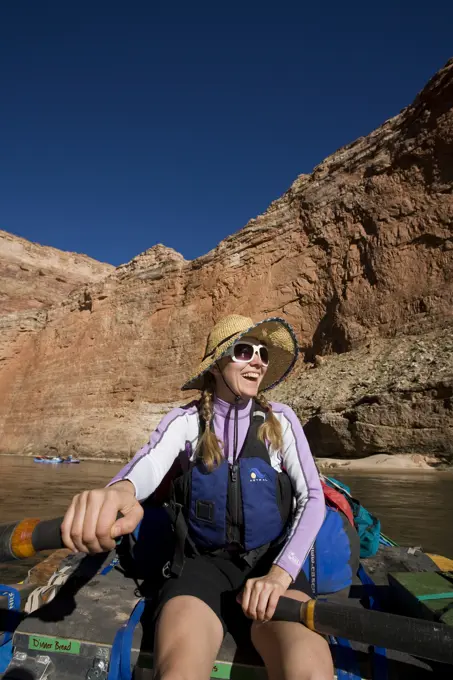 A woman rowing a raft in the Grand Canyon, Arizona.