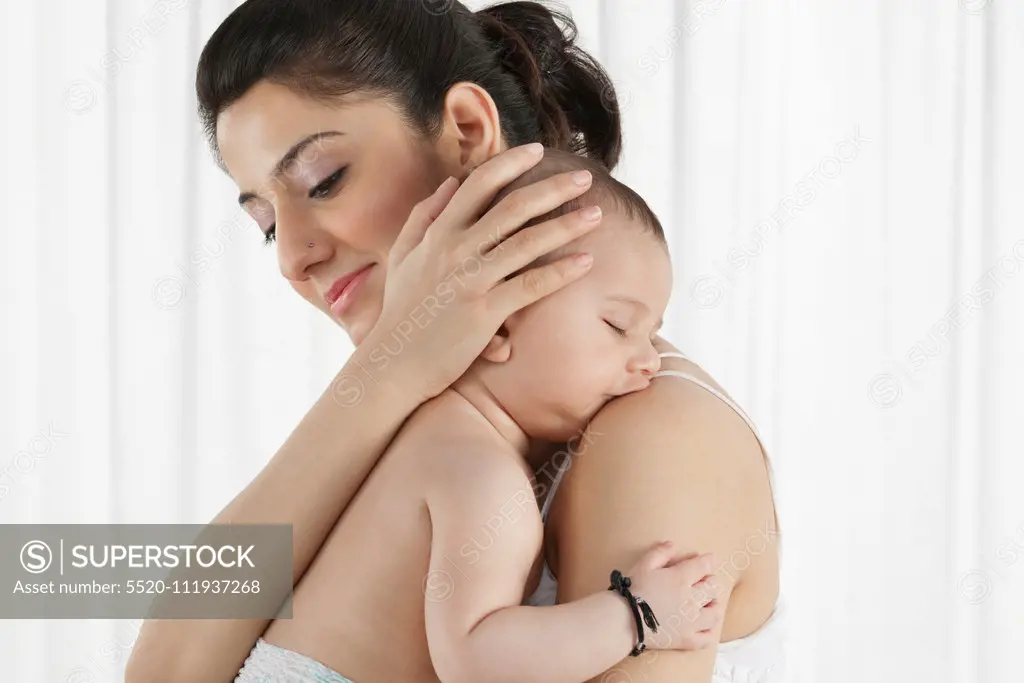 Mother holding a sleeping baby