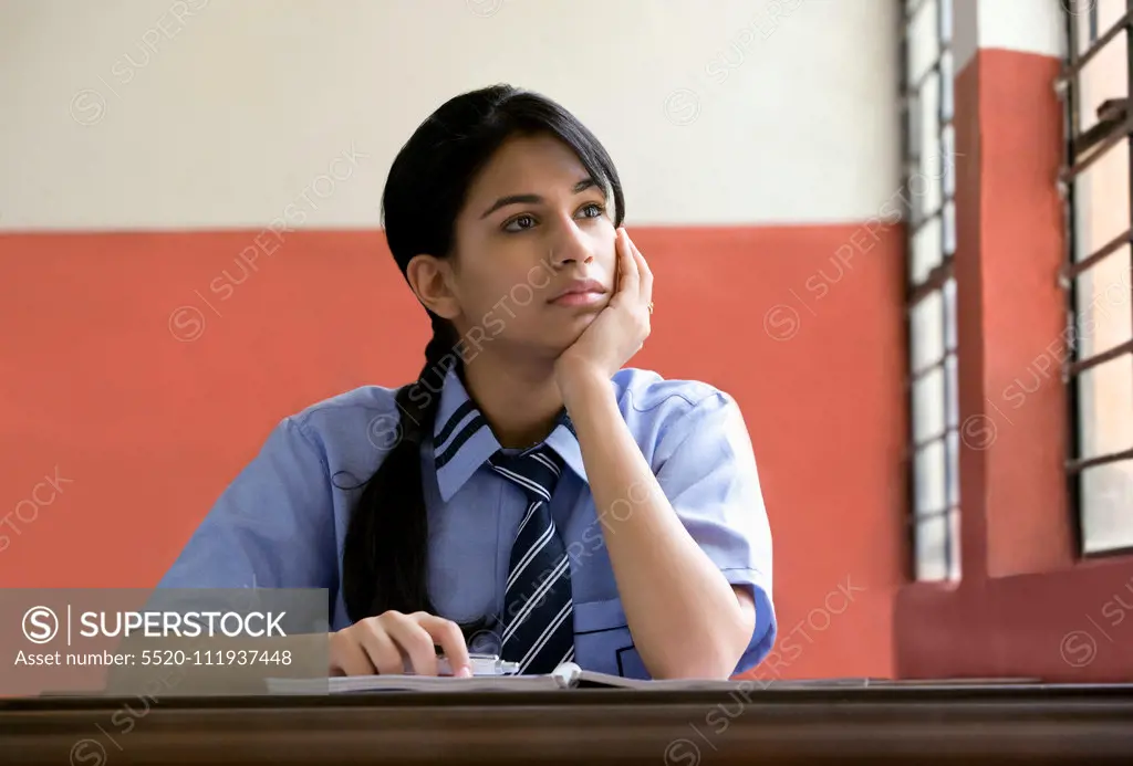 Girl daydreaming in a classroom