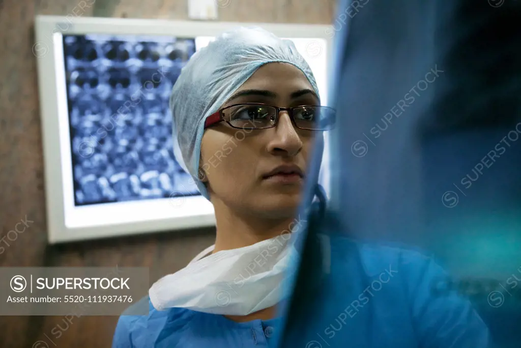 Surgeon looking at an X-ray chart