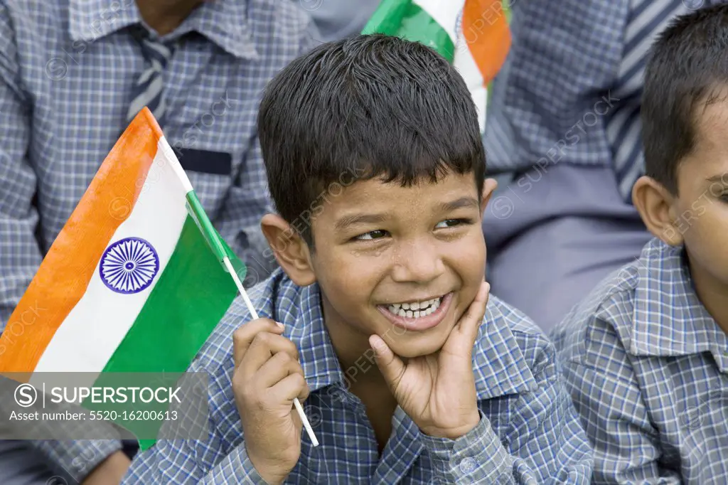 School boy holding the Indian flag