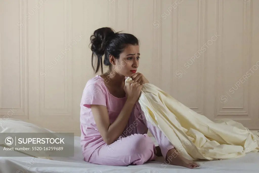 Young girl sitting alone in distress