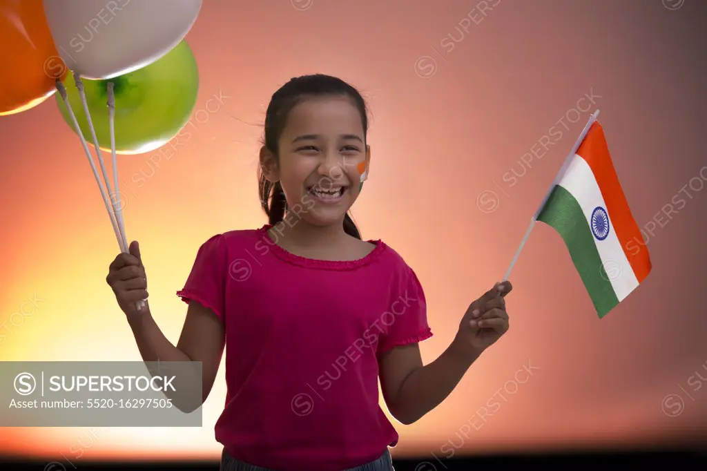 young girl holding flag and balloons, independence day