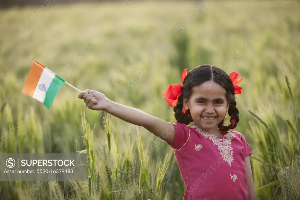 Portrait of a cheerful little girl holding an Indian flag, INDEPENDENCE DAY