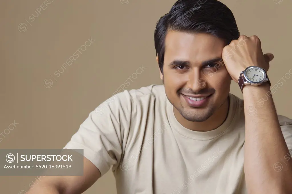 Portrait of handsome young man smiling over colored background