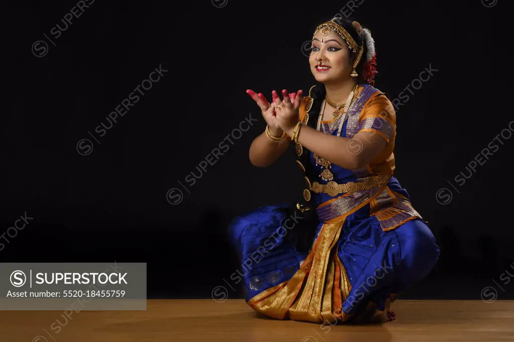 Kuchipudi dancer offering worshiping by offering a flower through her dance mudra