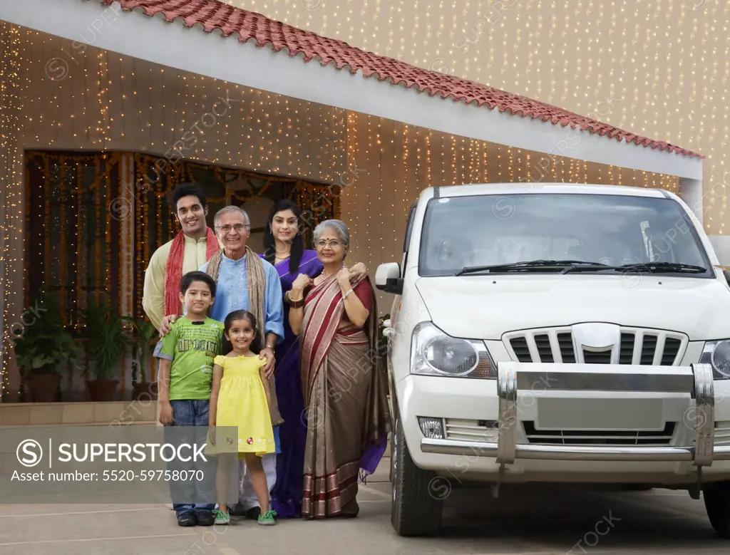 Portrait of a family standing with their car