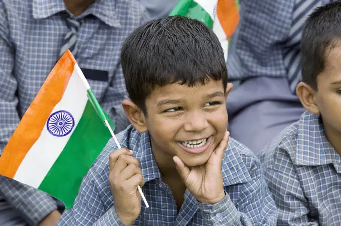 School boy holding the Indian flag