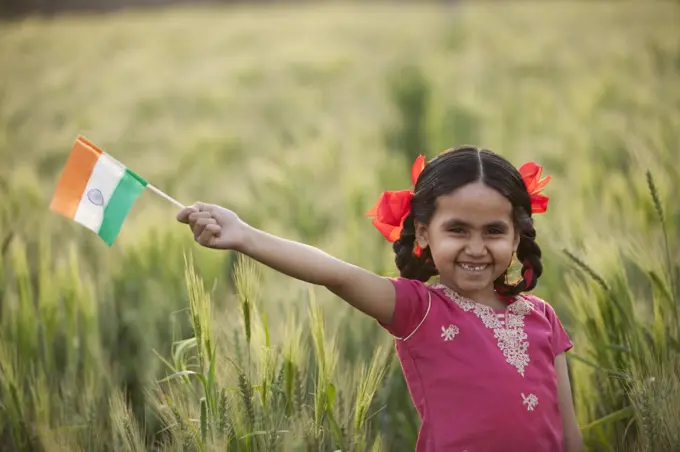 Portrait of a cheerful little girl holding an Indian flag, INDEPENDENCE DAY