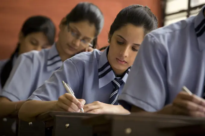 Students writing in a classroom