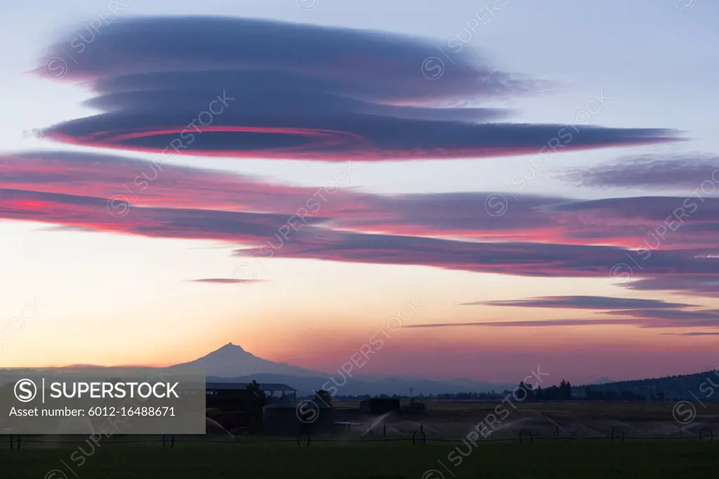 Pink hues are reflected of the clouds over Mount Jefferson Oregon