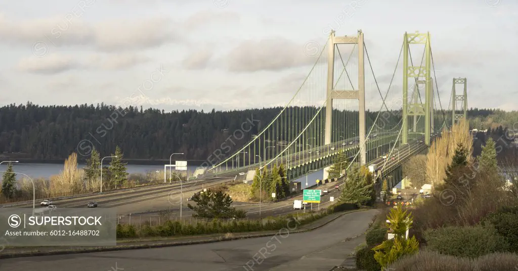 Early morning light illuminates the Tacoma Narrows Bridges Olympic Mountains in the background