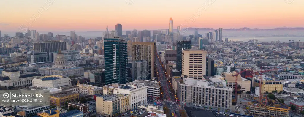 Orange hues seem to bounce off the tallest building as night comes to the San Francisco Bay area