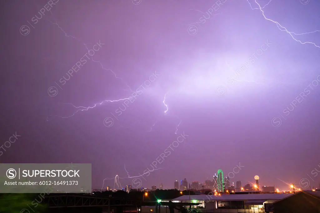 The sky is lit up purple over Dallas during a summer thunderstorm