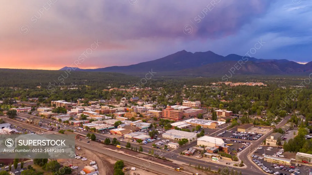 Blue and Orange color swirls around in the clouds at sunset over Flagstaff Arizona