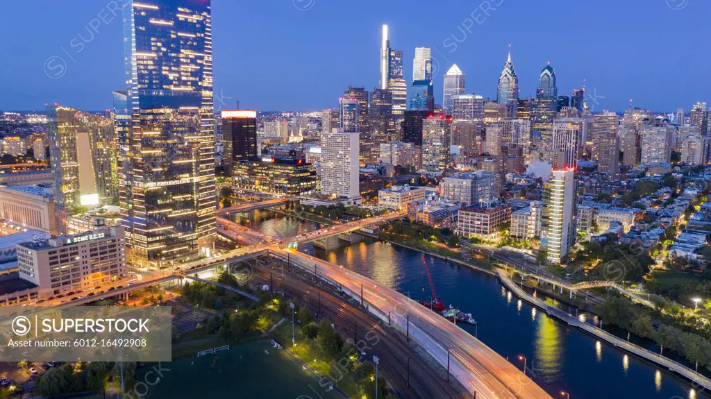 The city pumps out vibrant colorful light along the river in Philadelphia USA