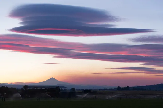 Pink hues are reflected of the clouds over Mount Jefferson Oregon