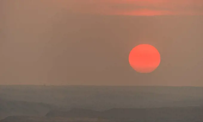 The sun gets low in the sky approaching the horizon at dusk