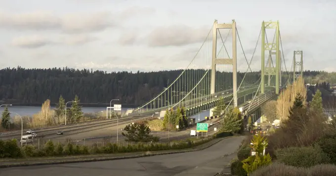 Early morning light illuminates the Tacoma Narrows Bridges Olympic Mountains in the background