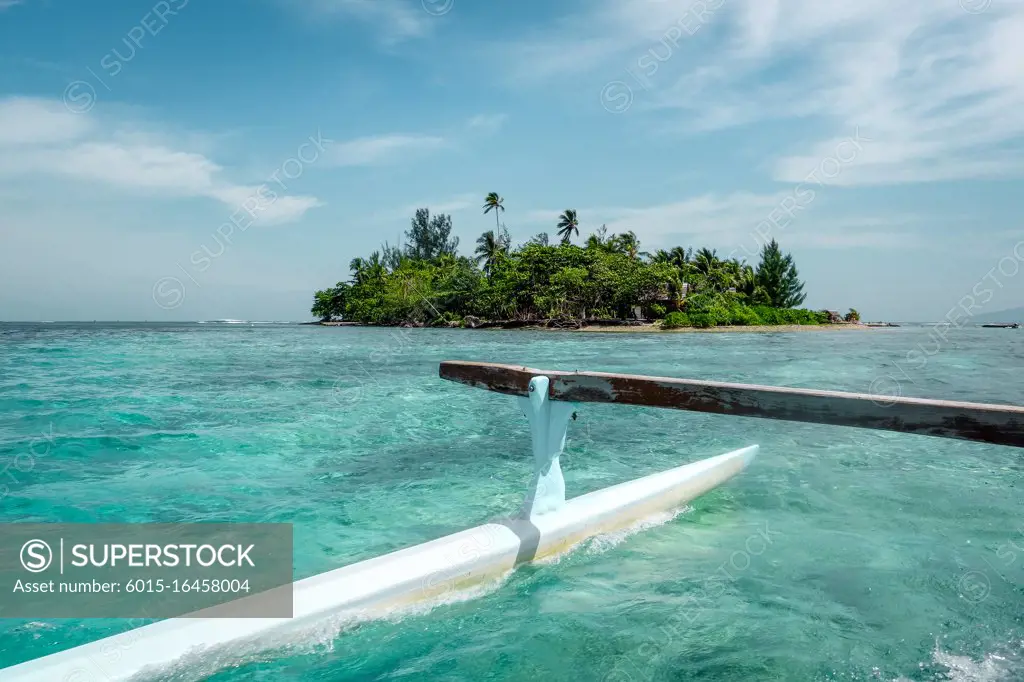 Pirogue on the way to paradise tropical atoll in Moorea Island lagoon. French Polynesia